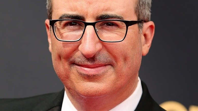 John Oliver with slight smile