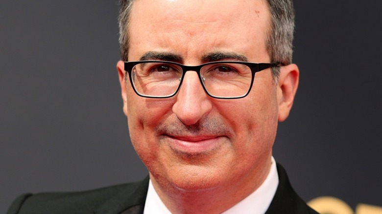 John Oliver smirking