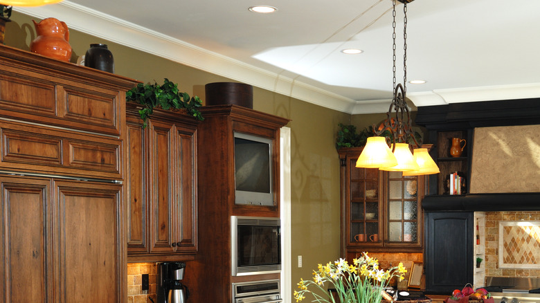 Curated pieces on top of kitchen cabinets feels cozy