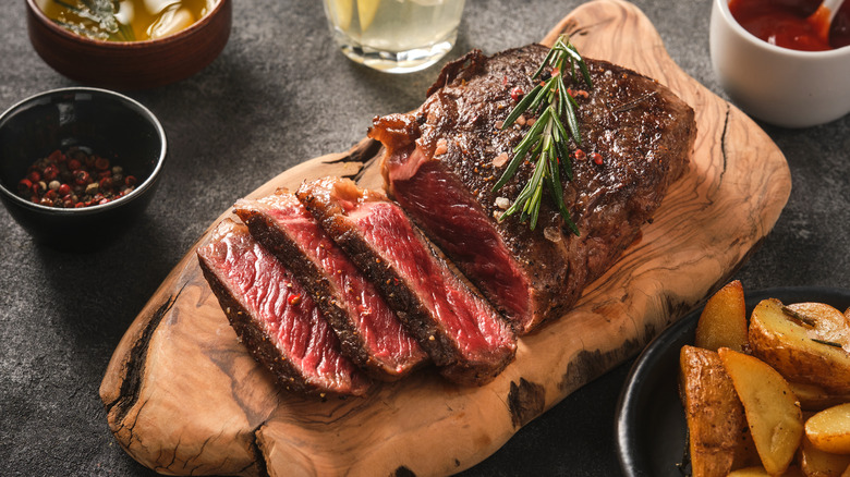 Sliced New York Strip steak on cutting board