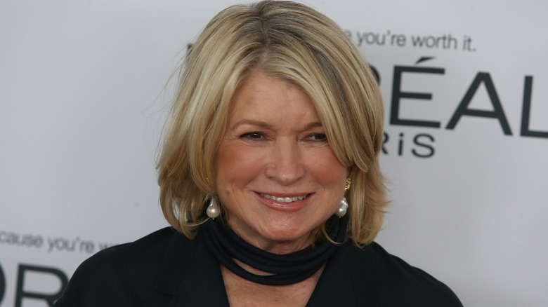 Martha Stewart in a black blouse and pearl earrings at a Loreal Paris appearance