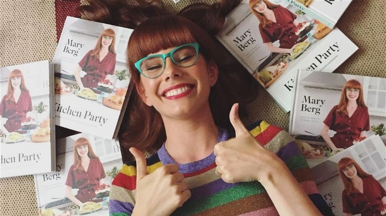 Mary Berg surrounded by her cookbooks
