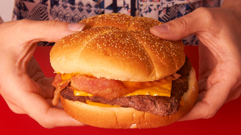 Someone holding a square-shaped burger