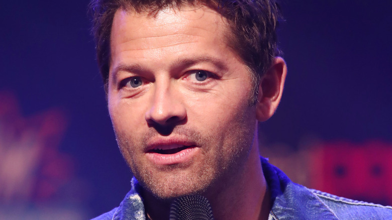 Misha Collins speaking into microphone