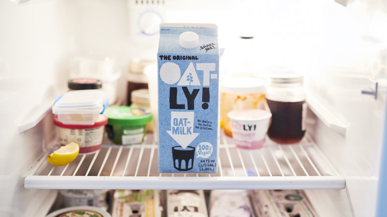 Carton of Oatly milk on refrigerator shelf