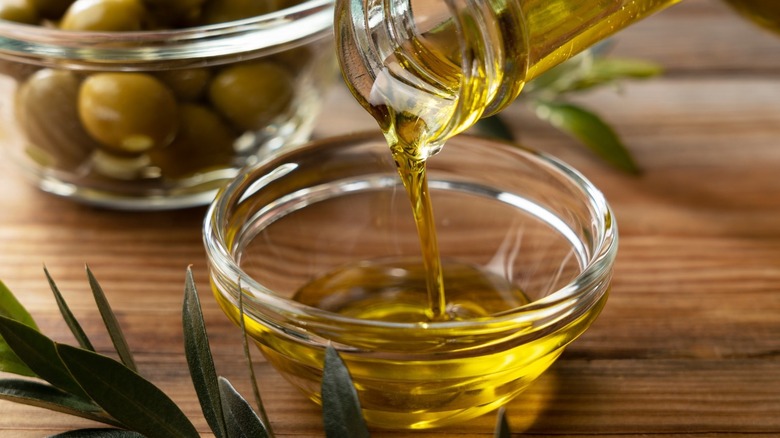 pouring olive oil into cup