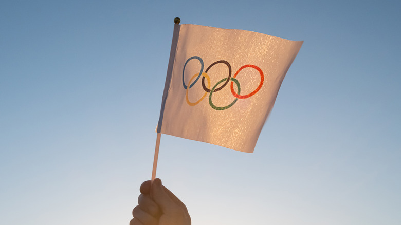 Person waving Olympic flag