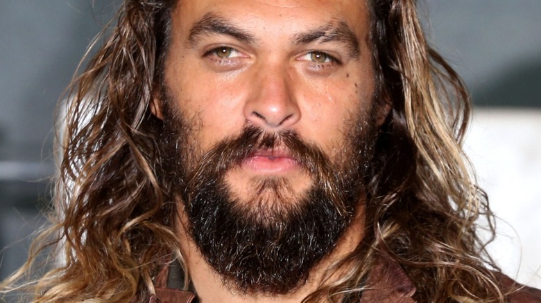 Jason Momoa with hair down and serious expression