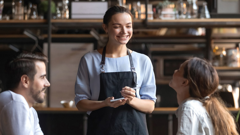 restaurant server taking couple's order