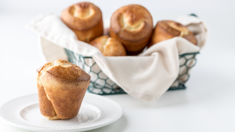 Fresh popovers in a basket with a white napkin
