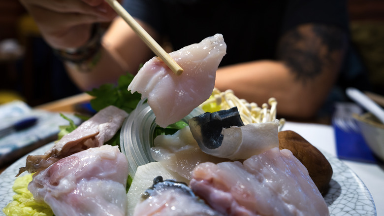 Eating fugu with chopsticks