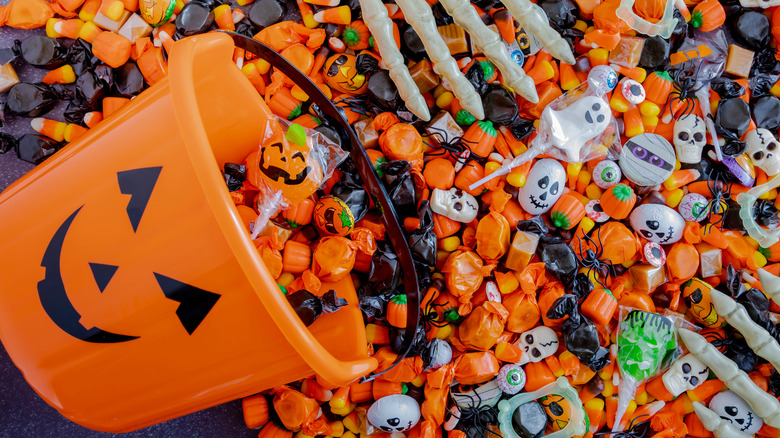 Halloween candy and a pumpkin bucket