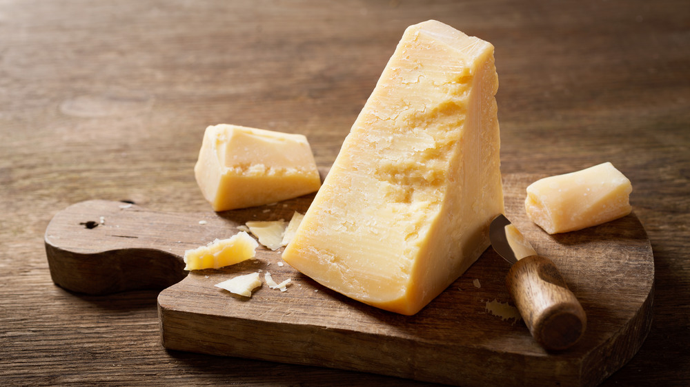 Parmesan cheese on wooden board