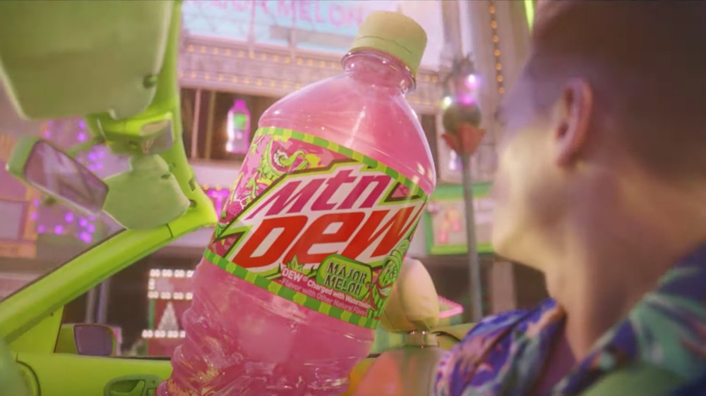 Pink bottle of Mountain Dew in car