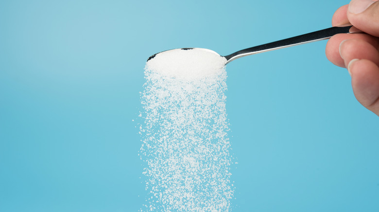 sugar pouring from teaspoon