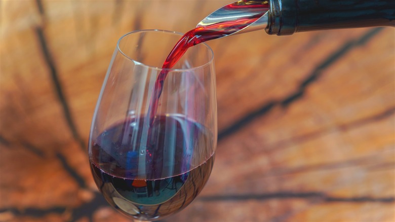 Pinot Noir wine being poured into a glass.