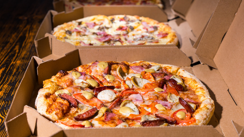 pizza with toppings in brown square boxes