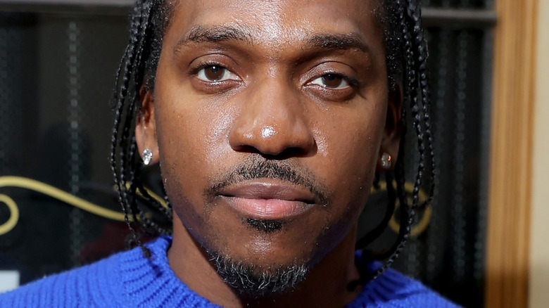 Pusha T with serious expression wearing diamond ear studs
