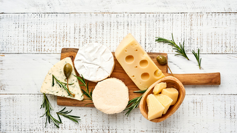 cheeses on board with rosemary