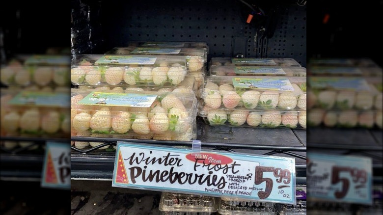 Boxes of pineberries on a shelf
