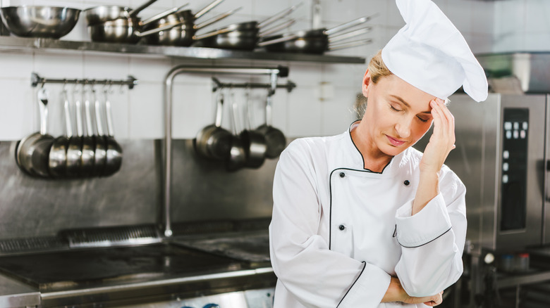 frustrated female chef in kitchen