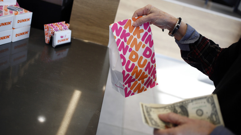 Customer paying at Dunkin'