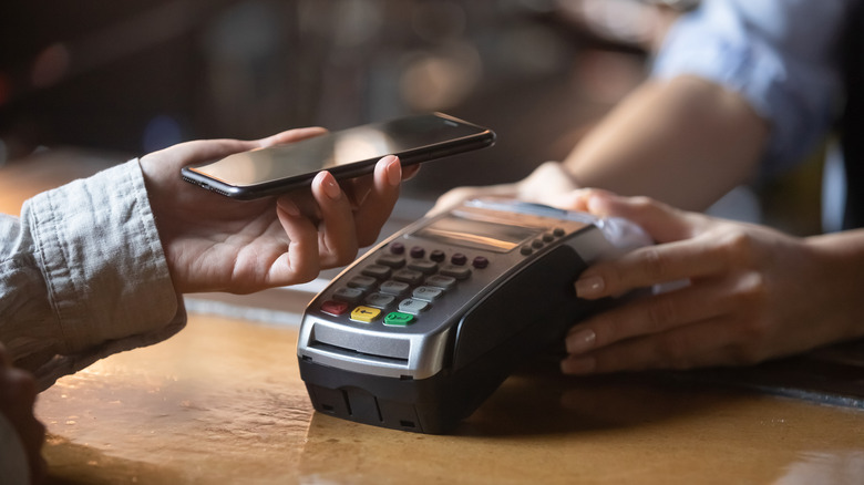 paying for food with contactless payment at restaurant