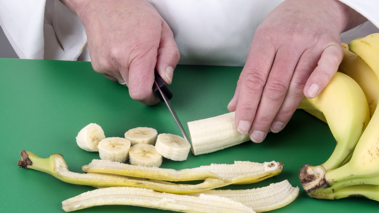 cutting banana on color coded board