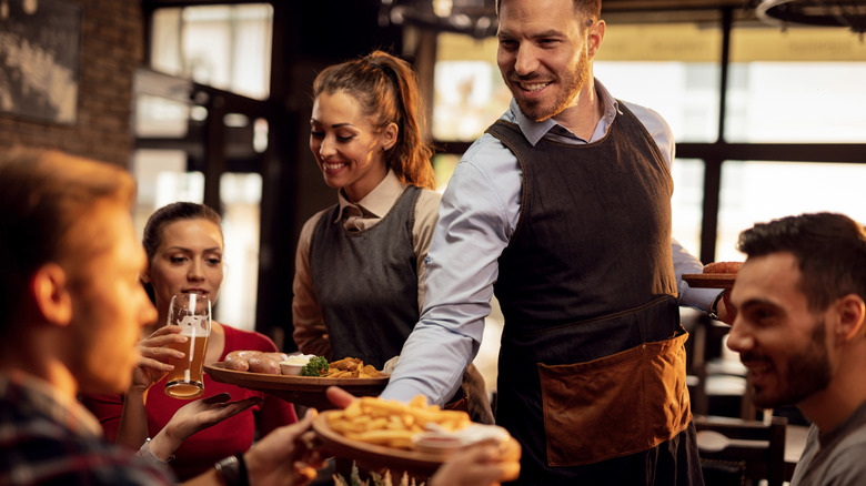 Waiters serving a restaurant table