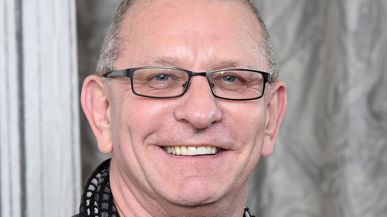 Robert Irvine smiling with black glasses