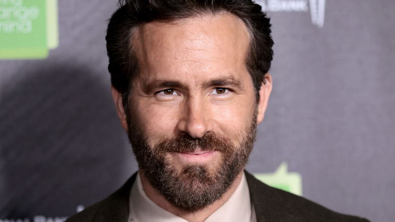 Bearded Ryan Reynolds smiling