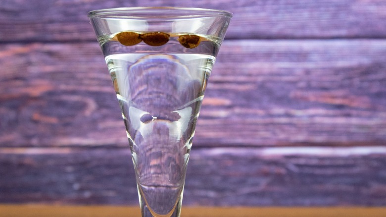 Shot of sambuca with three coffee beans floating on top