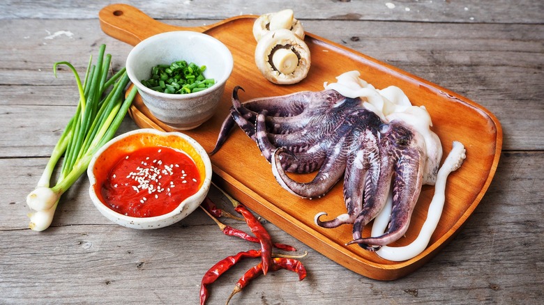 Preparing octopus on cutting board