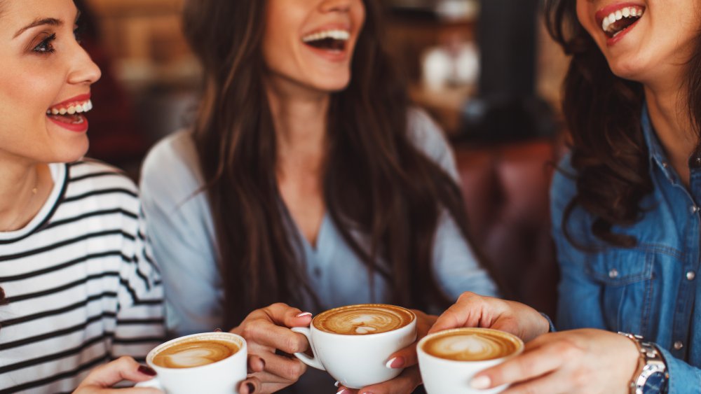 three women drinking lattes