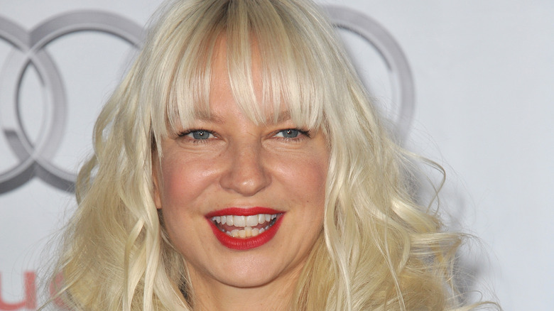 Sia headshot in front of Mercedes symbol 