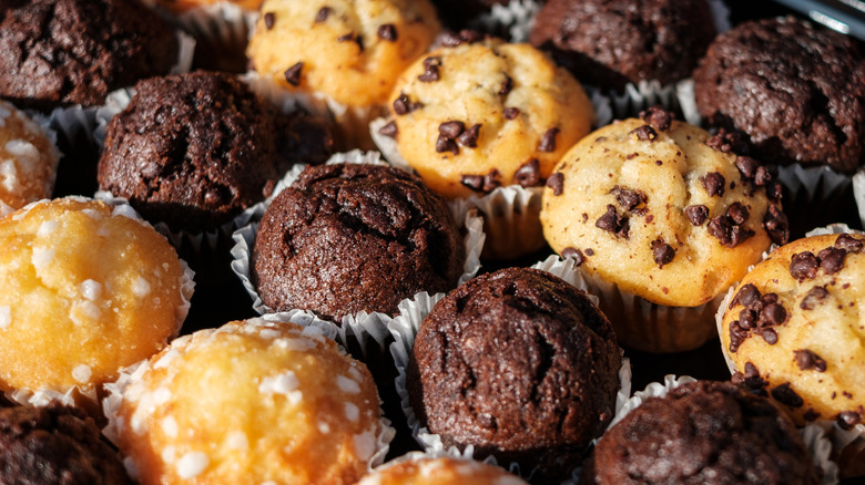Rows of different flavored mini muffins.