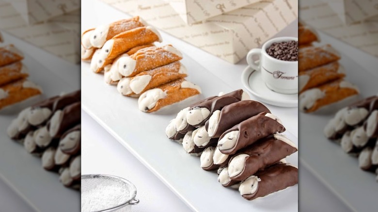 Ferrara's Bakery regular and chocolate-covered cannoli on a plate