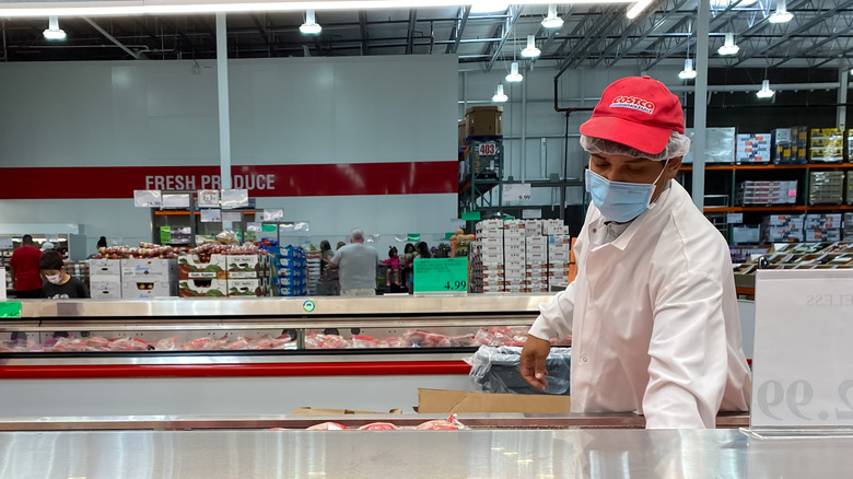 Costco worker sorting meat