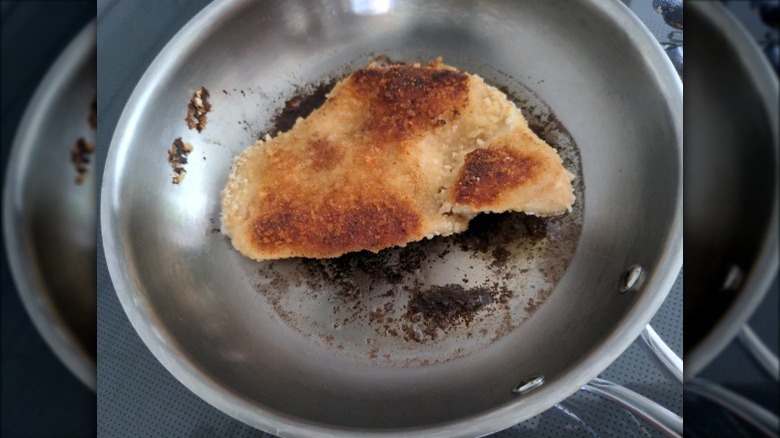A piece of chicken katsu on a pan