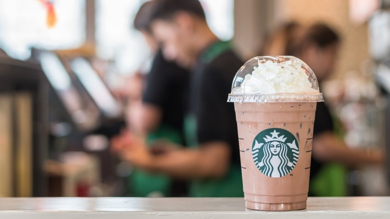 Starbucks frap with barista in the background