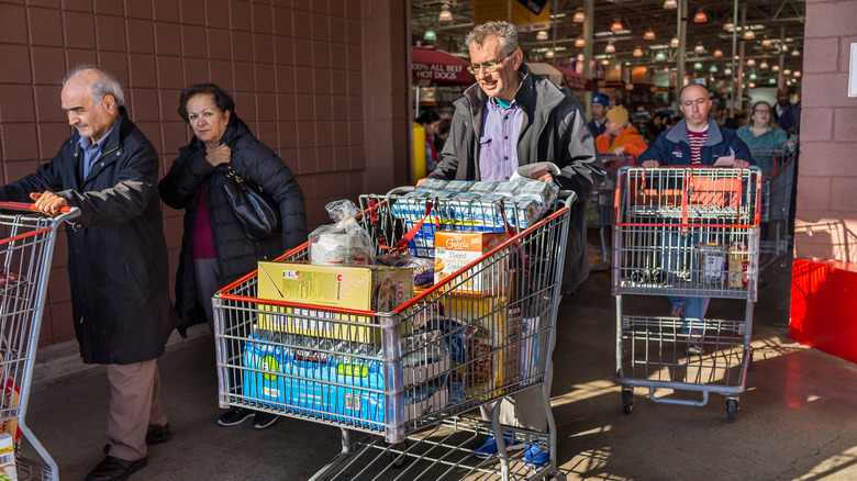 people pushing shopping carts 