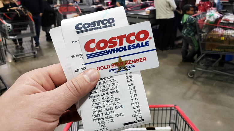 person holding Costco receipt  