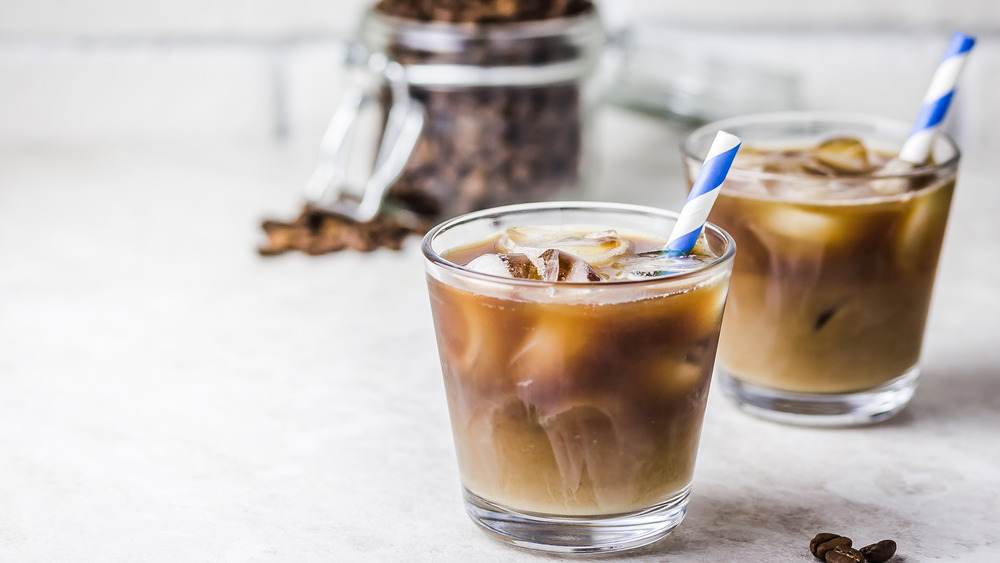 Cups of iced coffee with striped straws