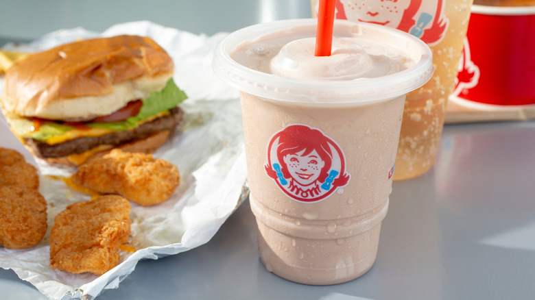 Wendy's meal with small chocolate Frosty on restaurant table.