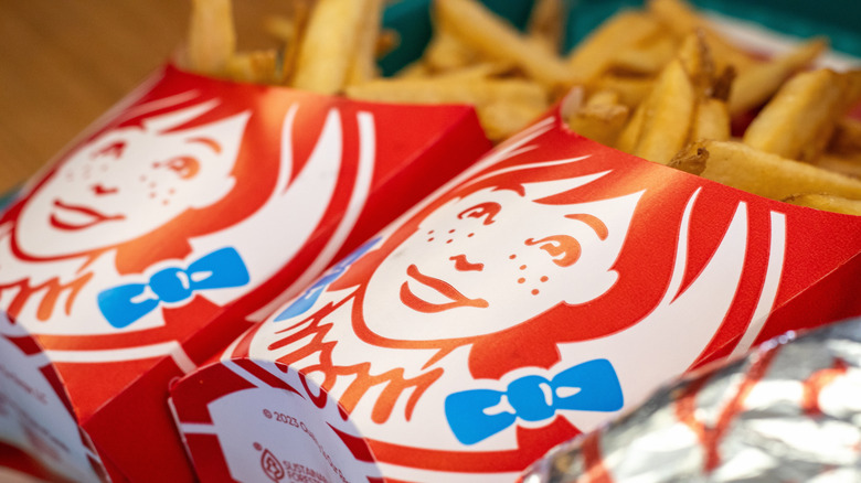 Two boxes of Wendy's french fries angled on tray.