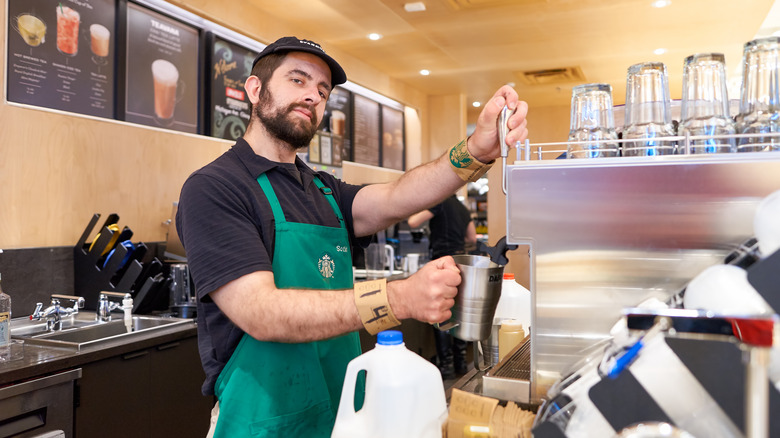 Starbucks barista steaming milk