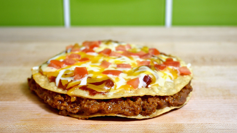 Mexican pizza on a green background