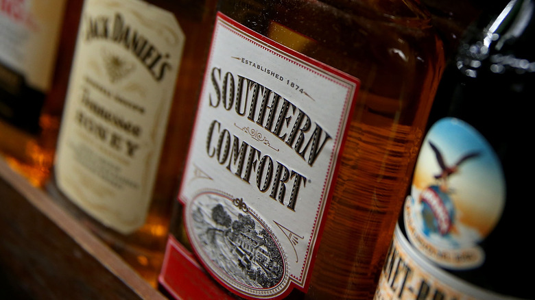Close-up of Southern Comfort bottle on shelf