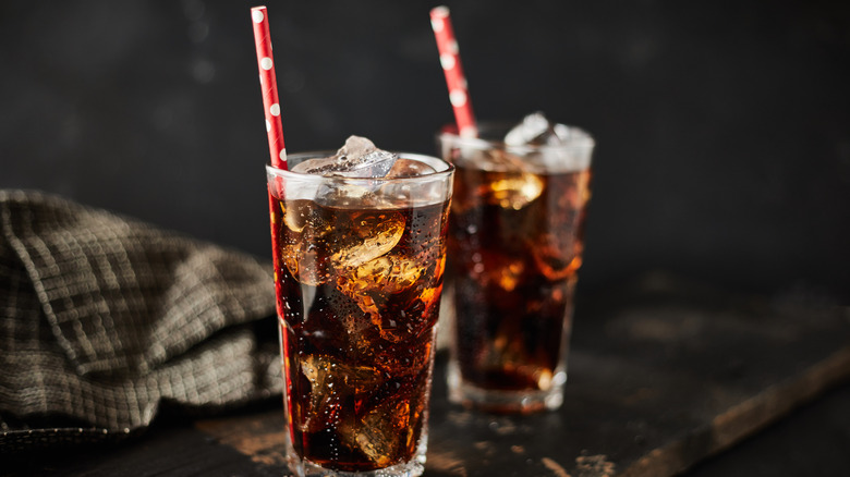 Two glasses of soda with ice and straws