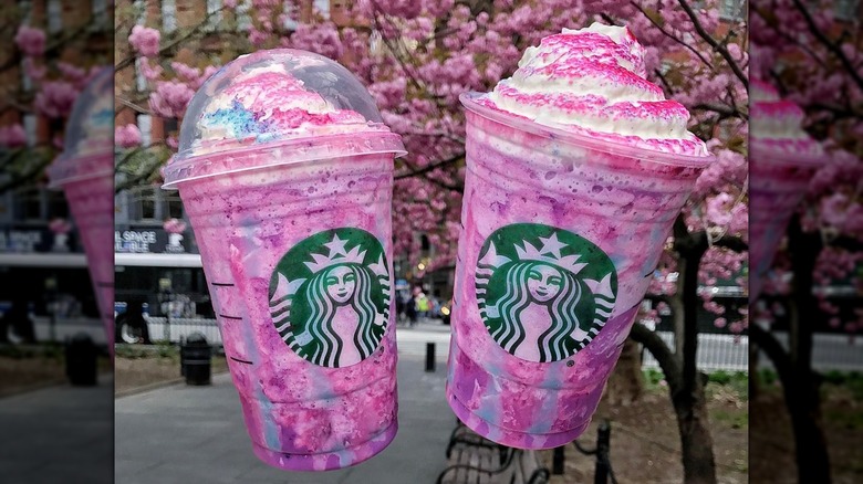 Two Starbucks Unicorn Frappuccinos at the park
